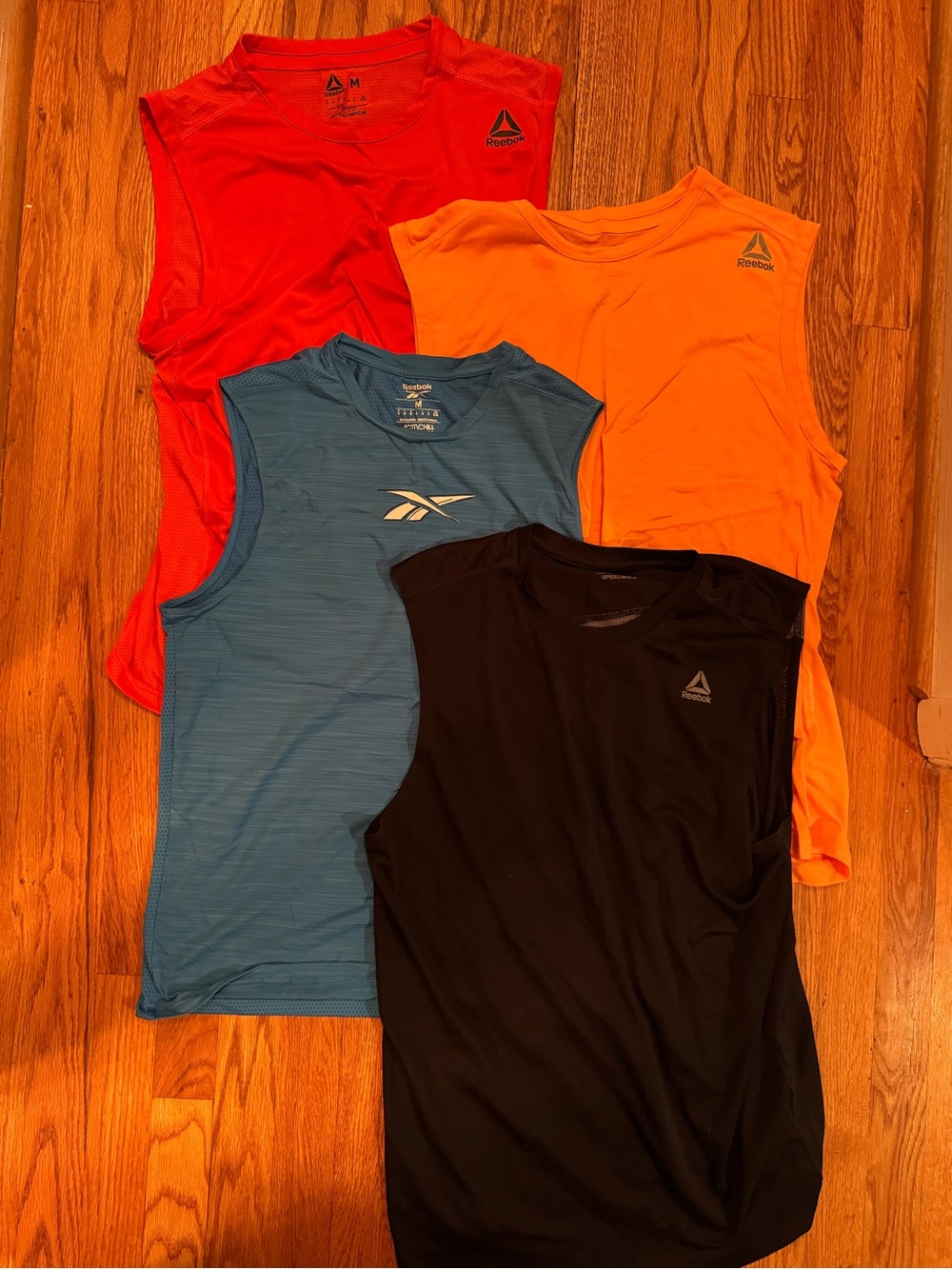 Reebok Men’s Sleeveless Training Tanks in Red, Orange, Blue, Black set of 4